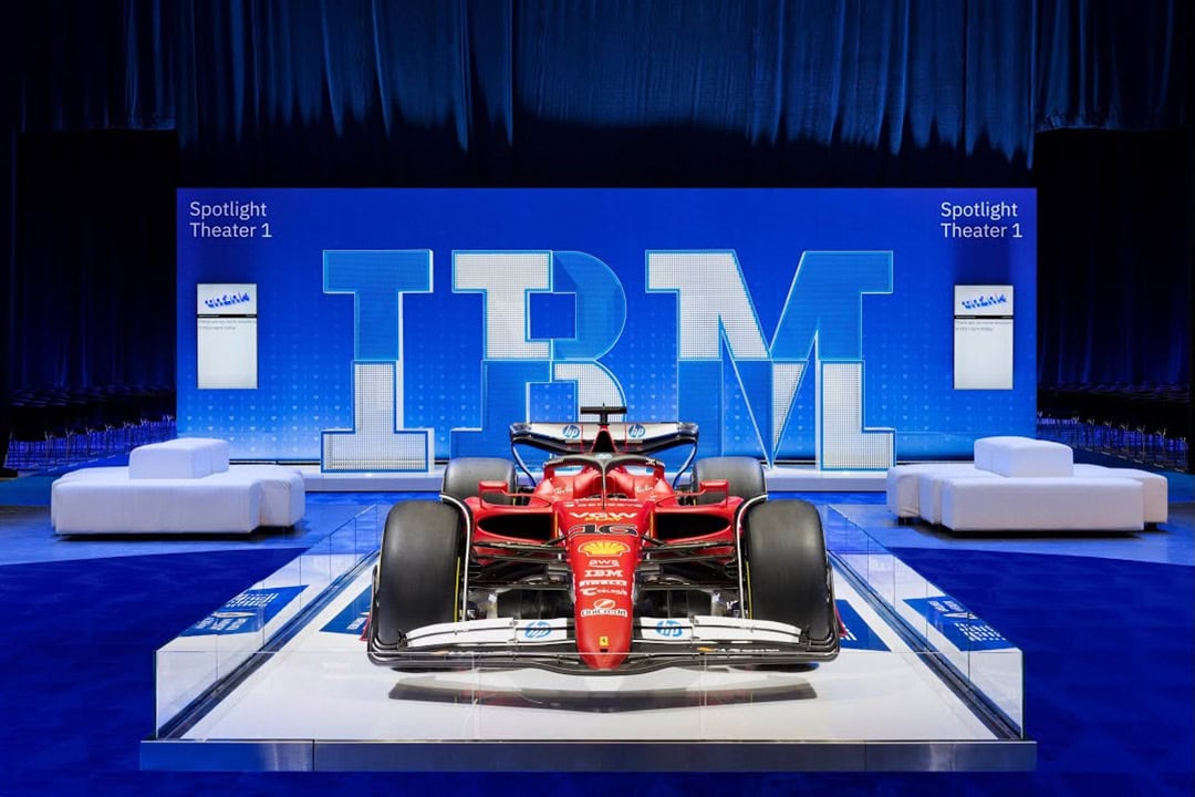 Innovative Formula 1 Car Display An eye-catching red Formula 1 race car showcased on a sleek platform in front of a large illuminated
