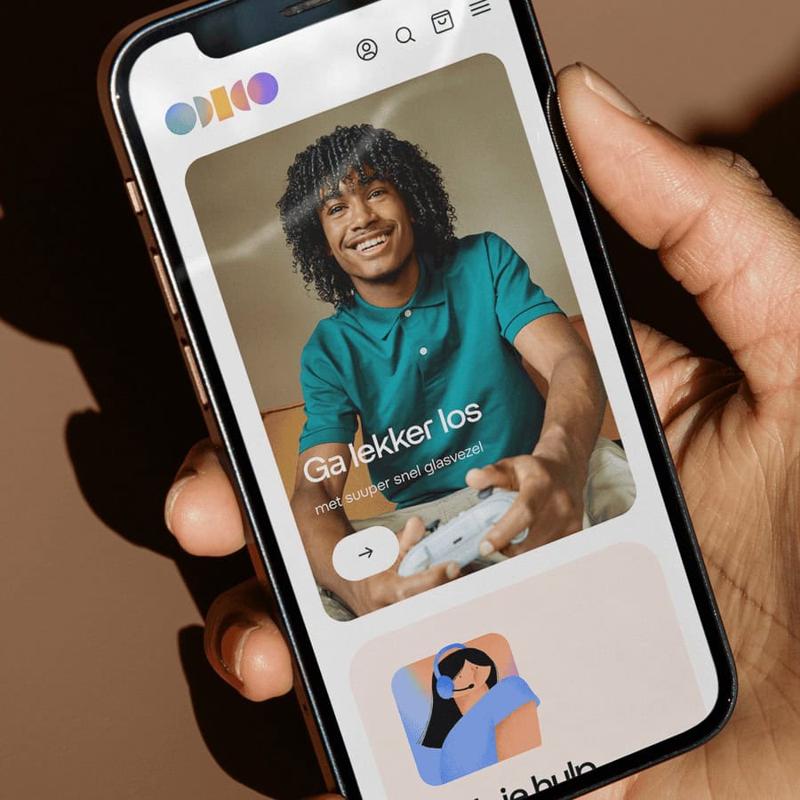 Smartphone displaying the Gamechanger app with a smiling person playing a game, highlighting social connection and entertainment features.